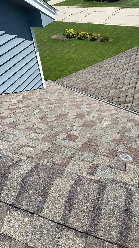 Before Hail damaged roof repair in Oconomowoc