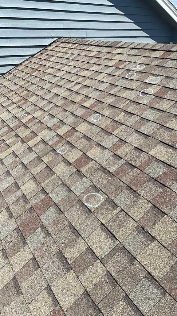 Before Hail damaged roof repair in Oconomowoc